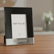 Black and silver photo frame with 'Artique' branding and 'Christening' engraving.