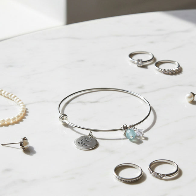 Cool Mum Bangle featuring a sentiment charm with other jewellery on table