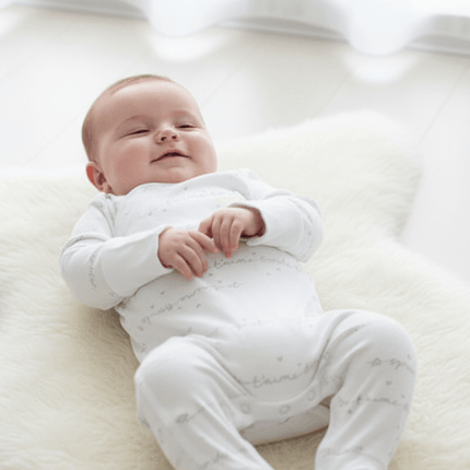 Baby wearing white bonds suit