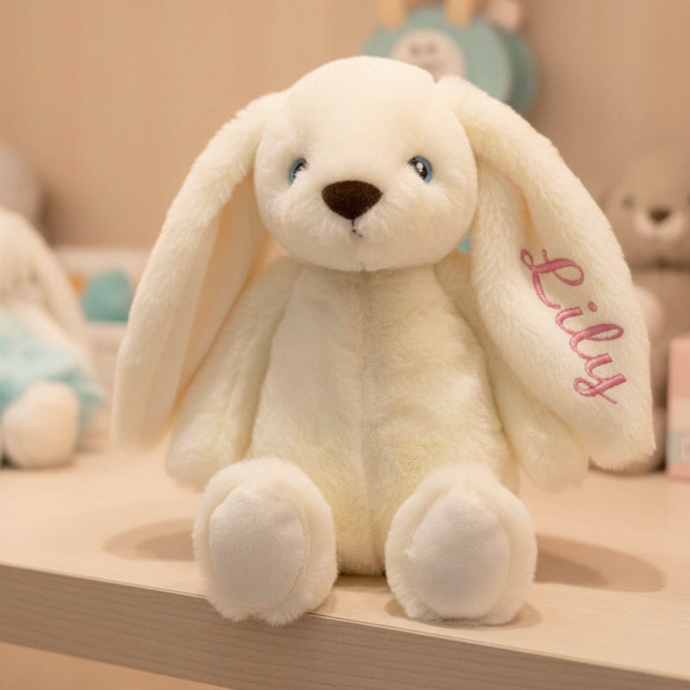 Personalised embroidered bunny plush toy with baby's name, sitting table