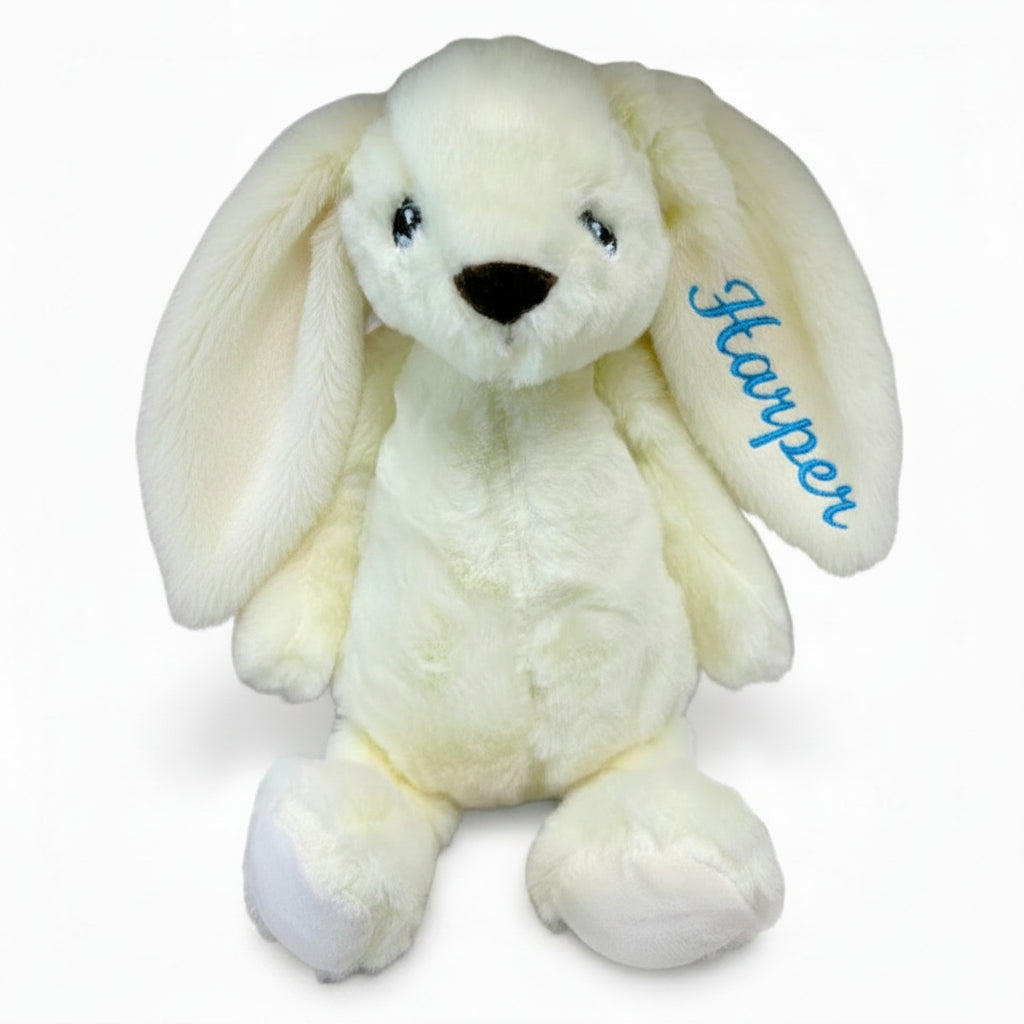 Cream bunny toy with name Adam embroidered on ear on a white background