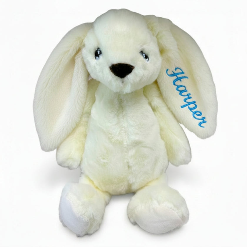 Cream bunny toy with name Adam embroidered on ear on a white background