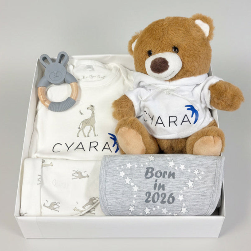 Corporate baby gift hamper full of branded baby clothes, teddy and toy