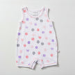 Baby romper with colorful dot pattern on a table background