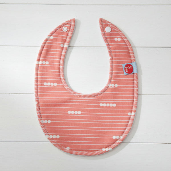 Baby bib with red and white pattern on a white background