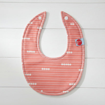 Baby bib with red and white pattern on a white background