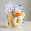 Plush duck toy with packaging labeled 'Bright Start' on a white background