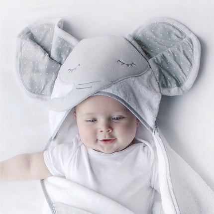 Baby wearing a gray elephant hooded towel on a light background