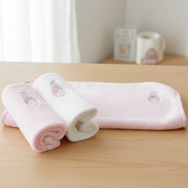 Set of three baby washers with embroidered bunny designs on a white background
