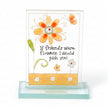 Decorative glass plaque with flowers and a quote on a white background