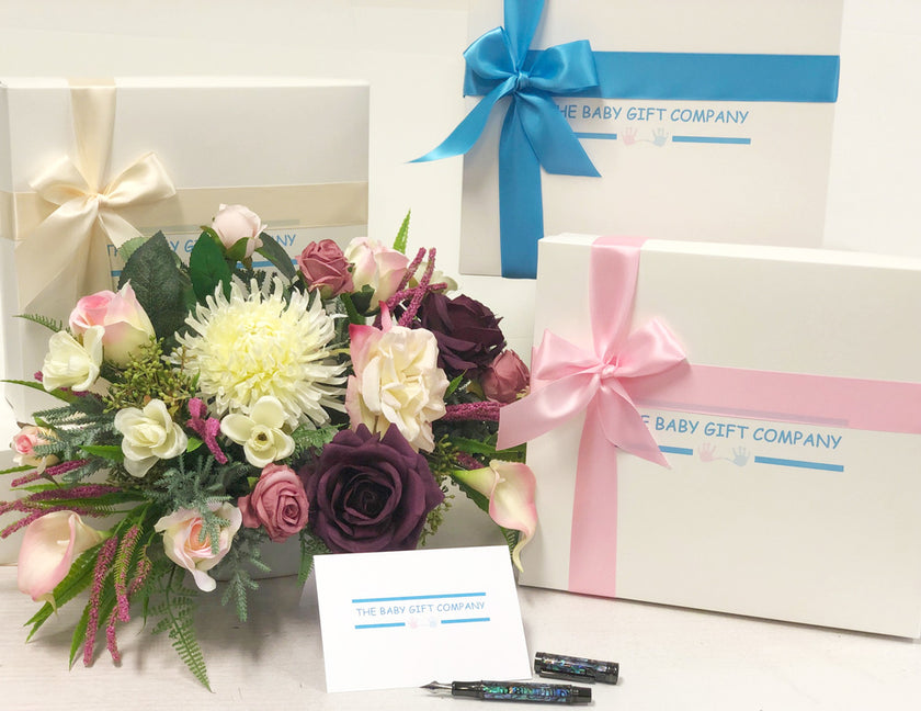Three gift boxes with ribbons and 'The Baby Gift Company' branding 