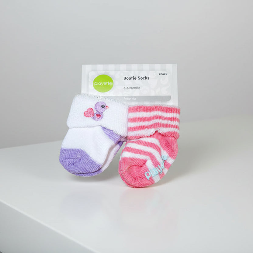 Two pairs of baby bootie socks with a Playette label on a white background