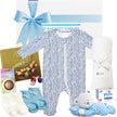 Baby gift set with blue and white baby onesie, socks, blanket, and toys on a white background.