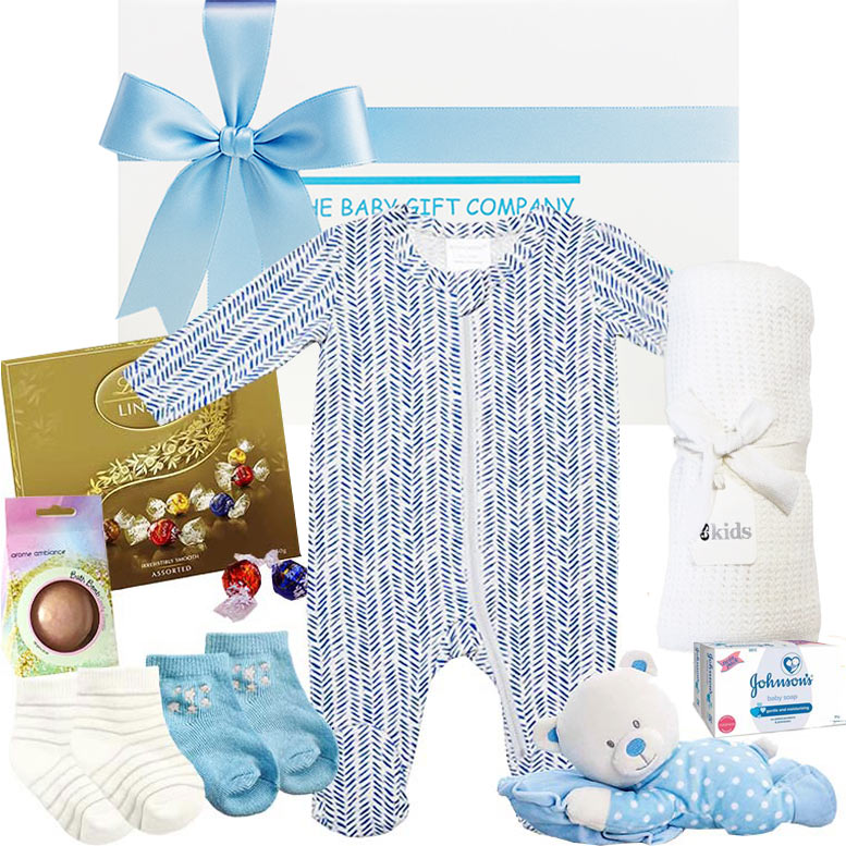 Baby gift set with blue and white baby onesie, socks, blanket, and toys on a white background.
