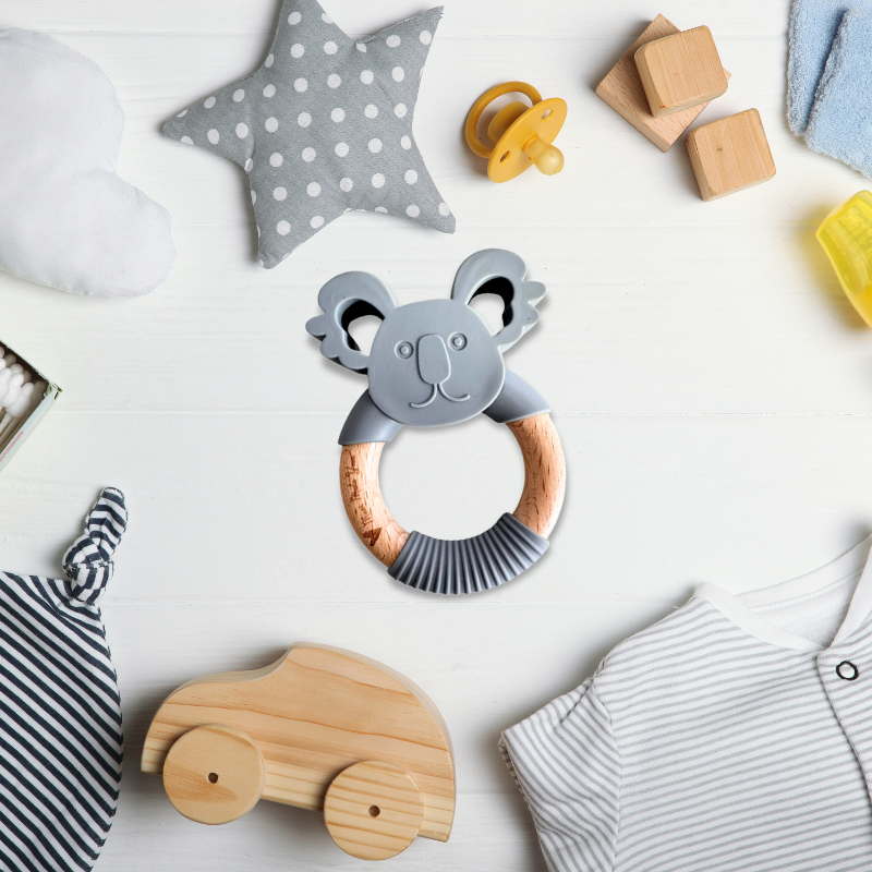 Collection of baby toys and items on a white surface