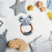 Collection of baby toys and items on a white surface