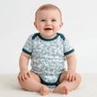 Blue romper on sitting baby