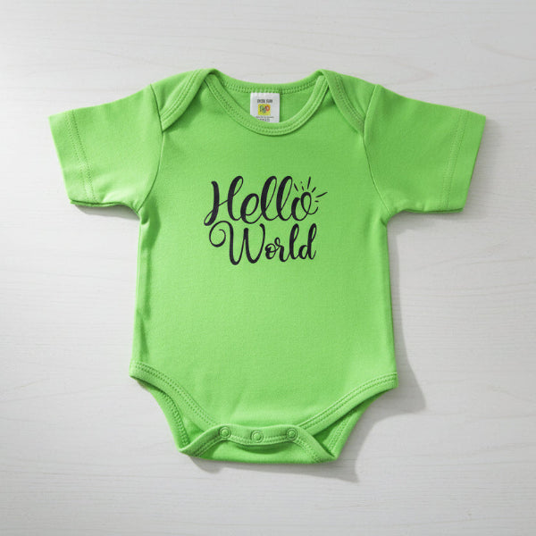 Green baby onesie with 'Hello World' text on a table background