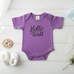 Purple baby onesie with 'Hello World' text on a white background