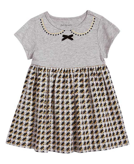 Grey baby girl dress with a patterned skirt on a white background
