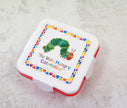 Children's snack box with 'The Very Hungry Caterpillar' design on a textured surface