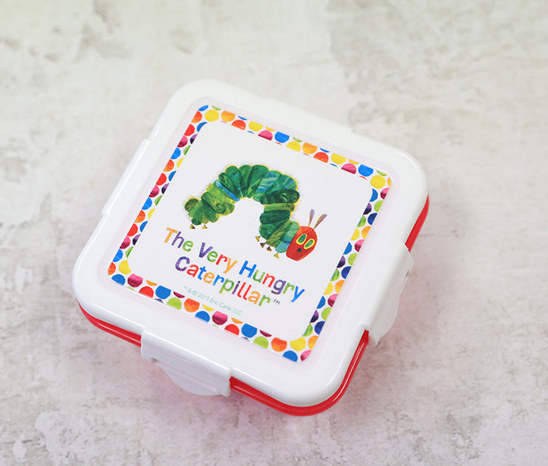 Children's snack box with 'The Very Hungry Caterpillar' design on a textured surface
