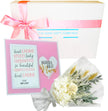 Gift set with a framed card, bouquet, and box from The Baby Gift Company on a white background.