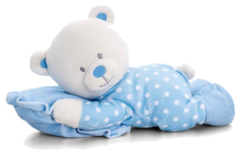 Plush teddy bear toy in blue pajamas with white polka dots on a white background