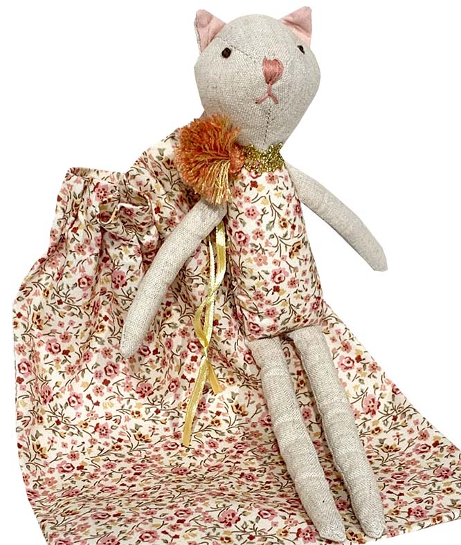Stuffed cat toy with a floral dress on a white background