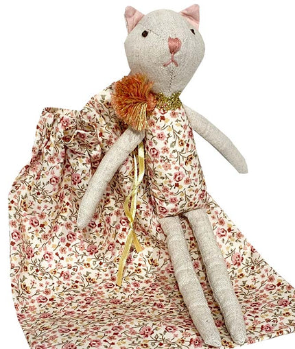 Stuffed cat toy with a floral dress on a white background