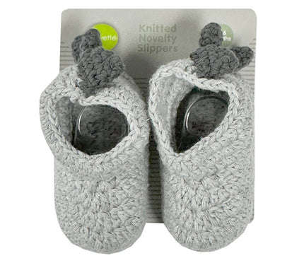 Pair of knitted novelty slippers with packaging on a white background