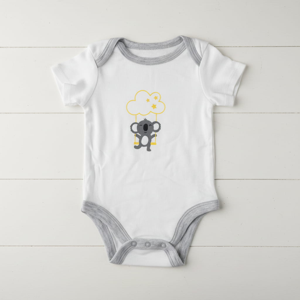 White and grey Koala baby romper on table