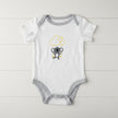White and grey Koala baby romper on table