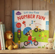 Children's book titled 'Lift-the-Flap Number Fun' with a child on a bike and traffic light illustration on bookshelf