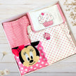 Baby clothing set with Minnie Mouse design in a box on a wooden surface.