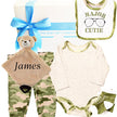 Baby gift set with teddy bear, bib, and clothing items in a gift box on a white background