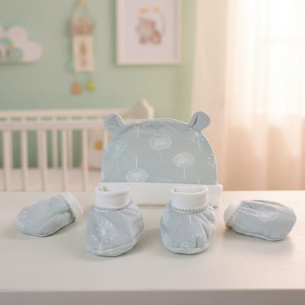 Baby hat, mittens, and booties set with meadow flower pattern on a table in nursery baby background