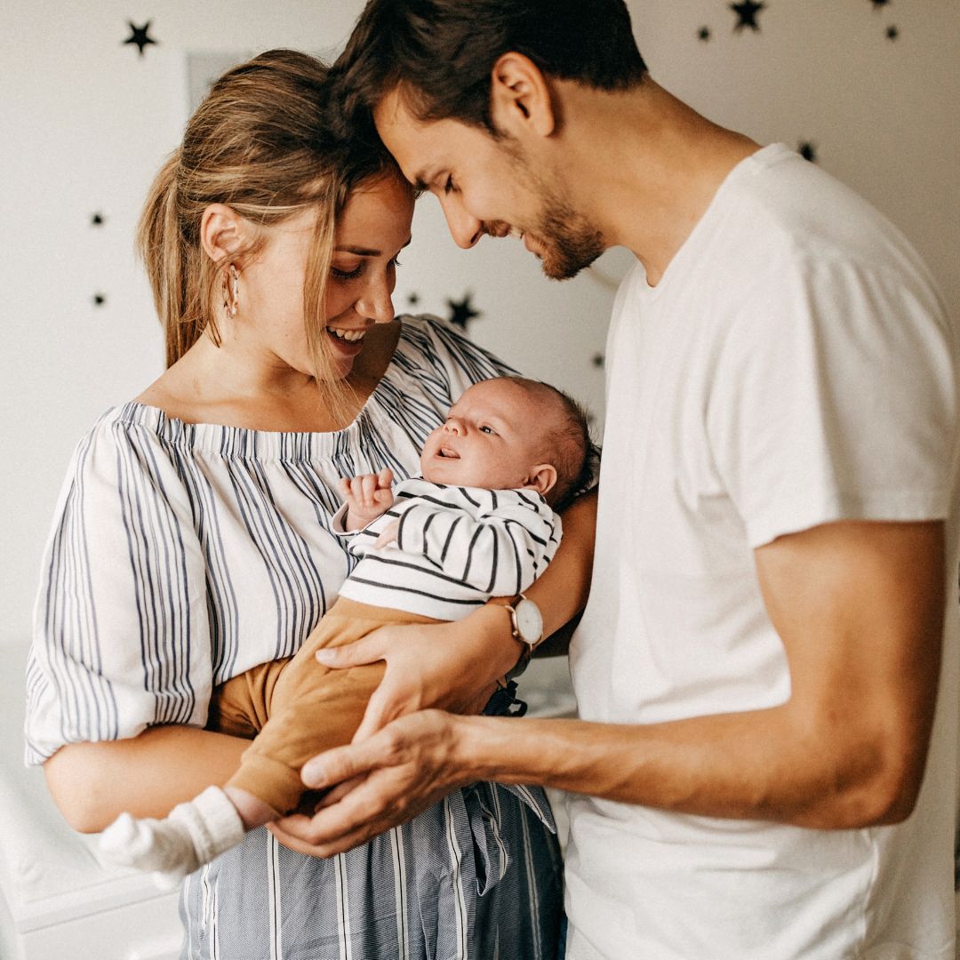 Family of three with a baby indoors