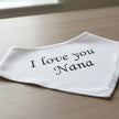 White bandana with 'I love you Nana' text on a table background