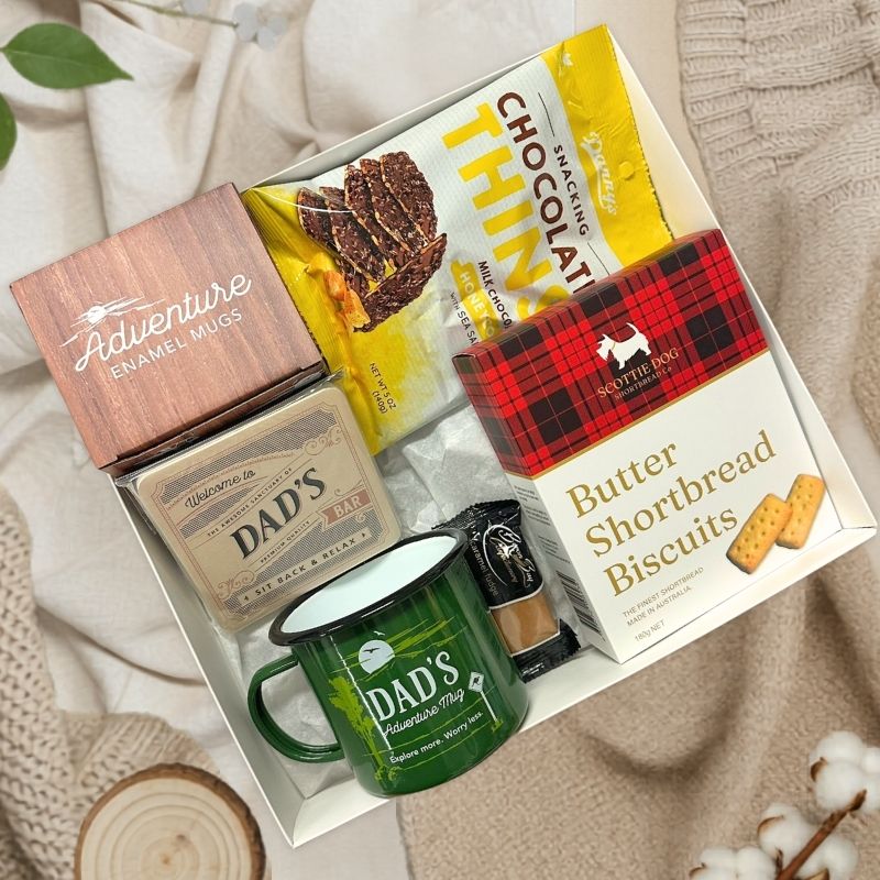 New Dad Relax & Unwind Gift Box with biscuits and dad mug on fabric background