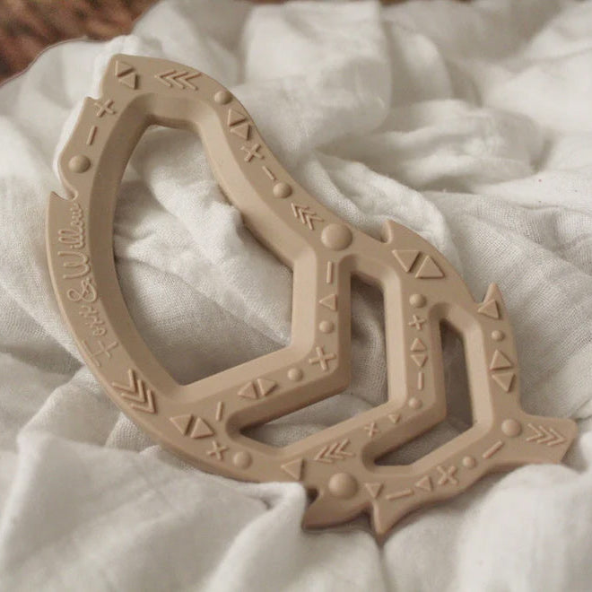 Nude Feather Teether toy on fabric
