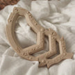 Nude Feather Teether toy on fabric