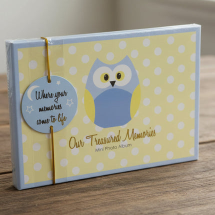 Mini photo album with owl design and text on a yellow polka dot background