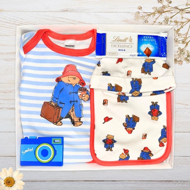 Paddington bear themed baby gift hamper with baby clothes and camera toy