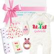Baby gift set with personalized onesie, Johnson's baby bottle, and other items on a white background.