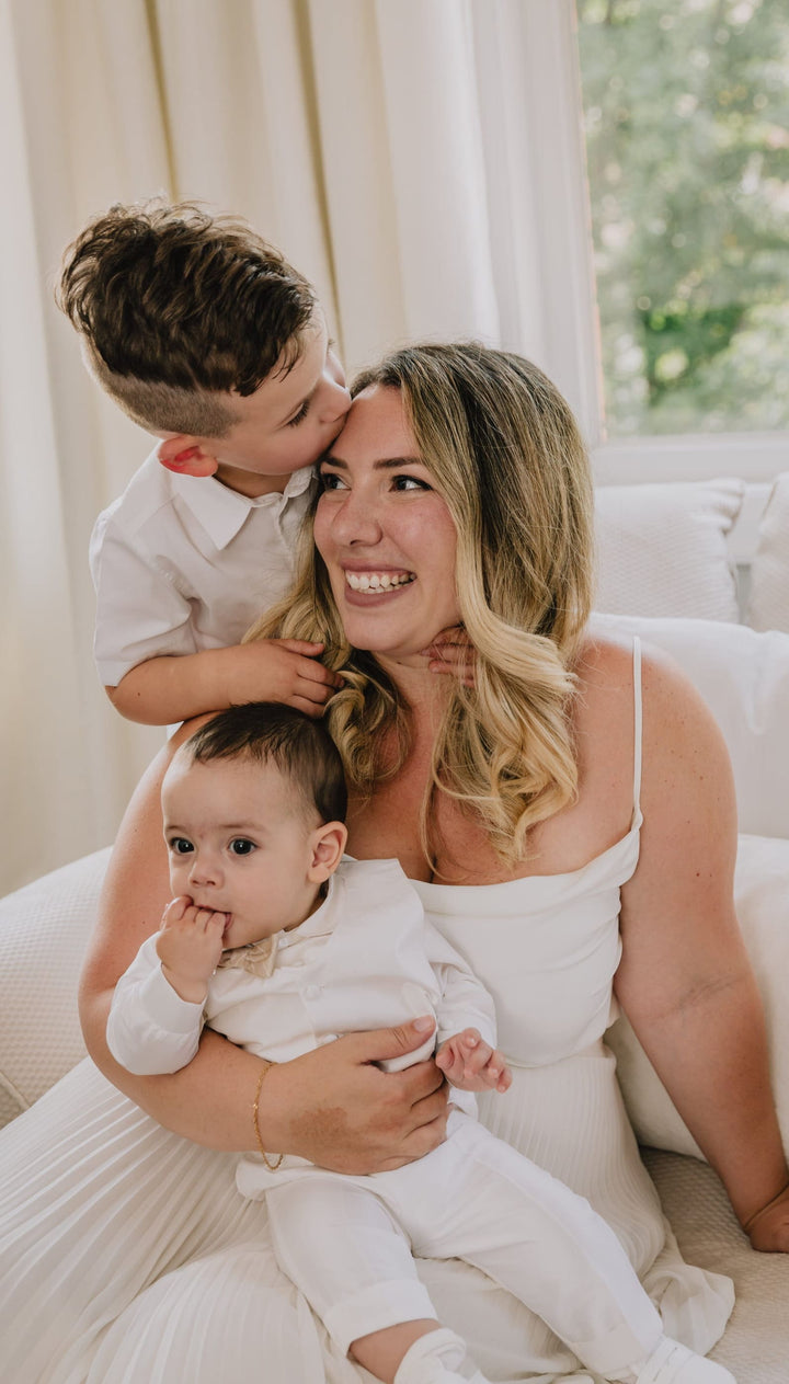 mother smiling with her young children