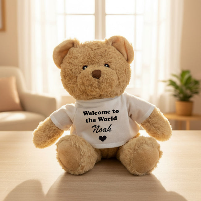 Brown teddy bear with 'Noah' on a wooden table background