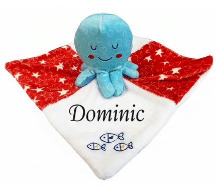 Blue octopus-shaped plush toy with a white blanket featuring the name 'Dominic' and fish designs on a white background.