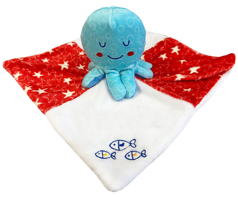 Blue plush octopus toy on a red blanket with white stars, personalized with 'Dominic'.