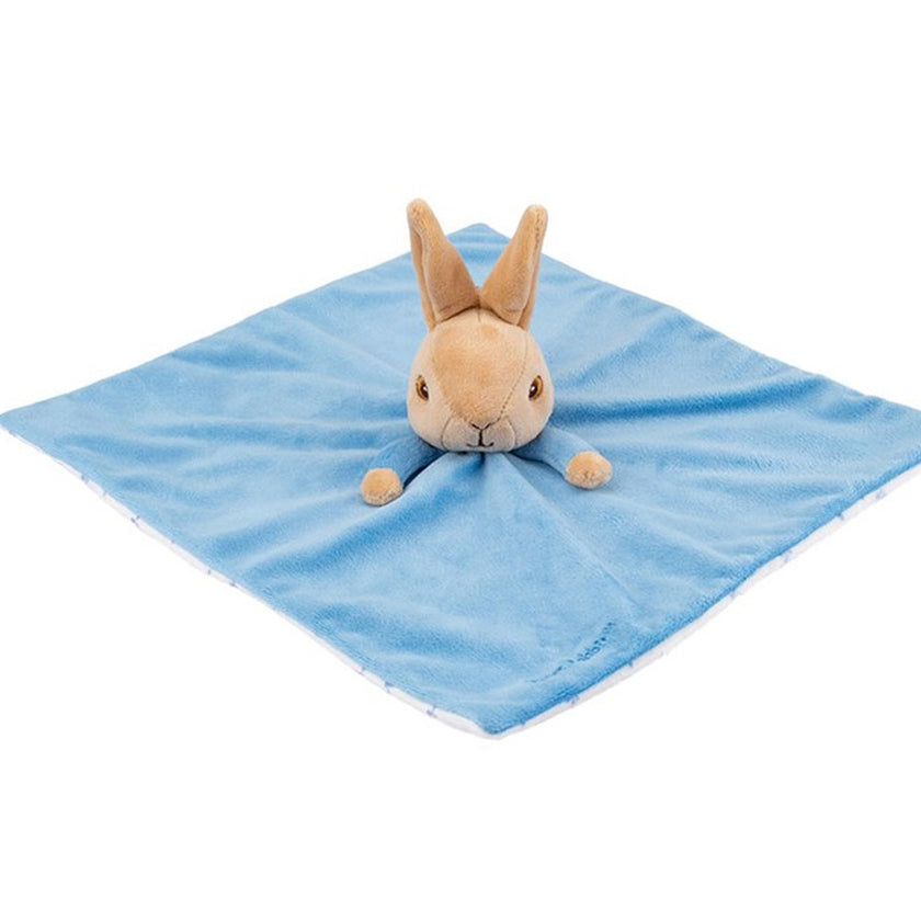 Plush rabbit toy on a blue blanket with a white background